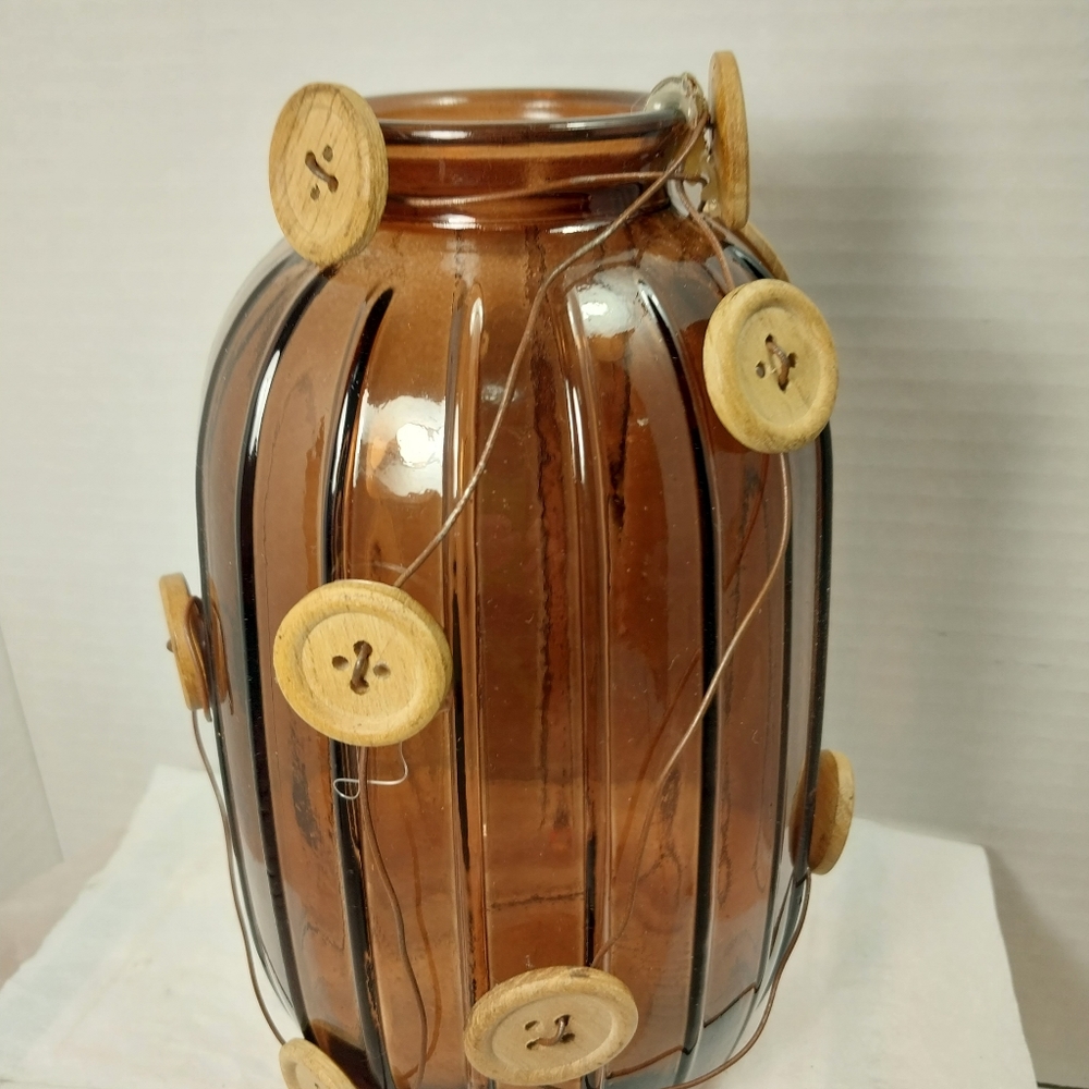 Amber vase decorated with buttons